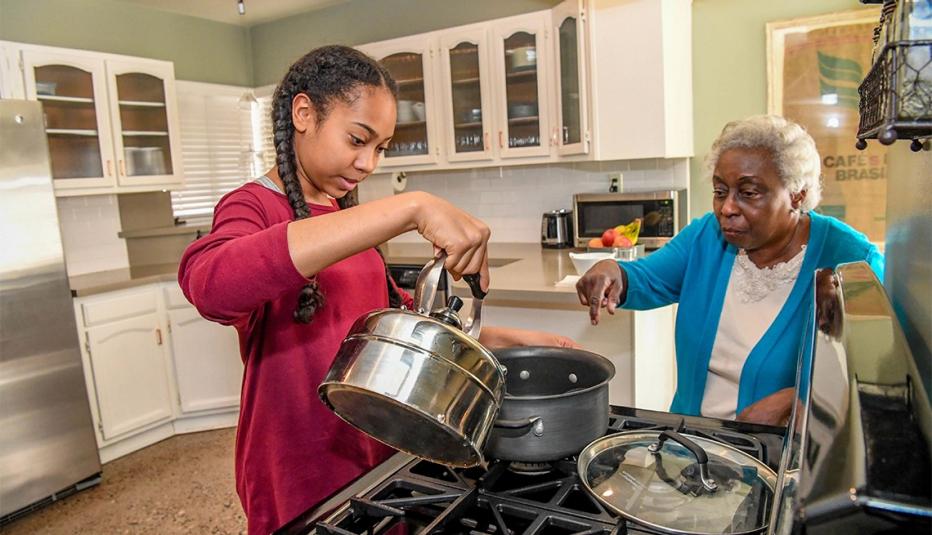 Grandmother and granddaughter cook togehter in the kitchen in Phoenix, Arizona.
